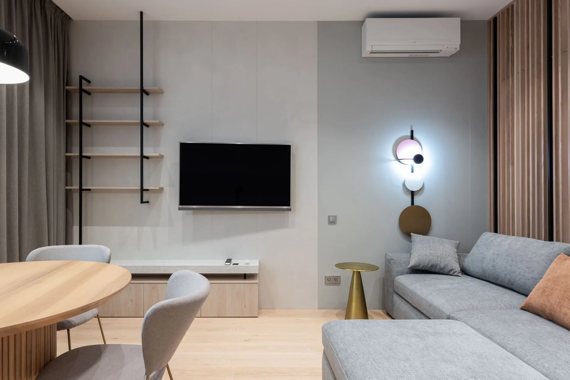 Living room with a wall-mounted split system unit, weighing ducted vs split system options