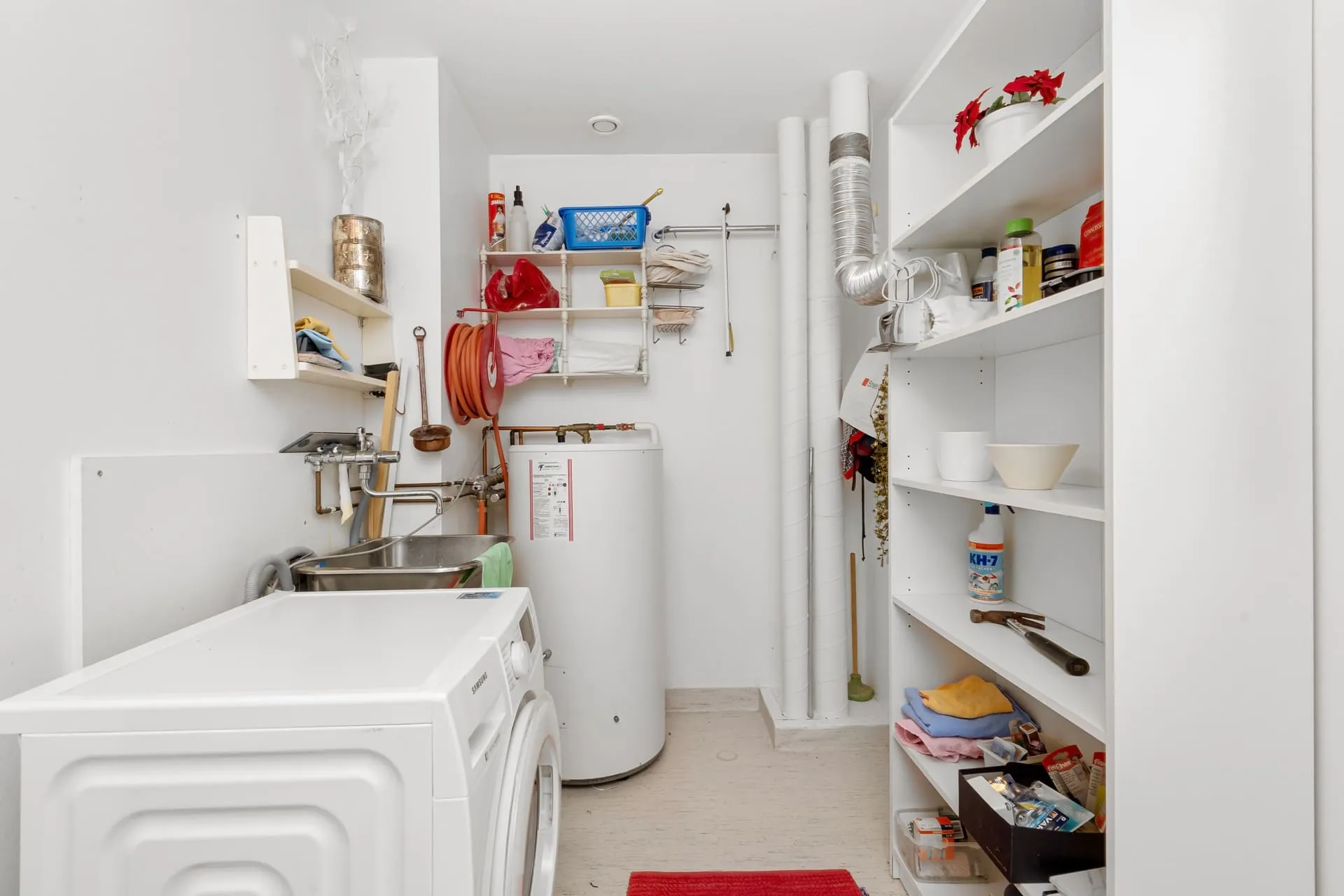 Storage hot water tank in a home laundry, part of hot water system replacement cost