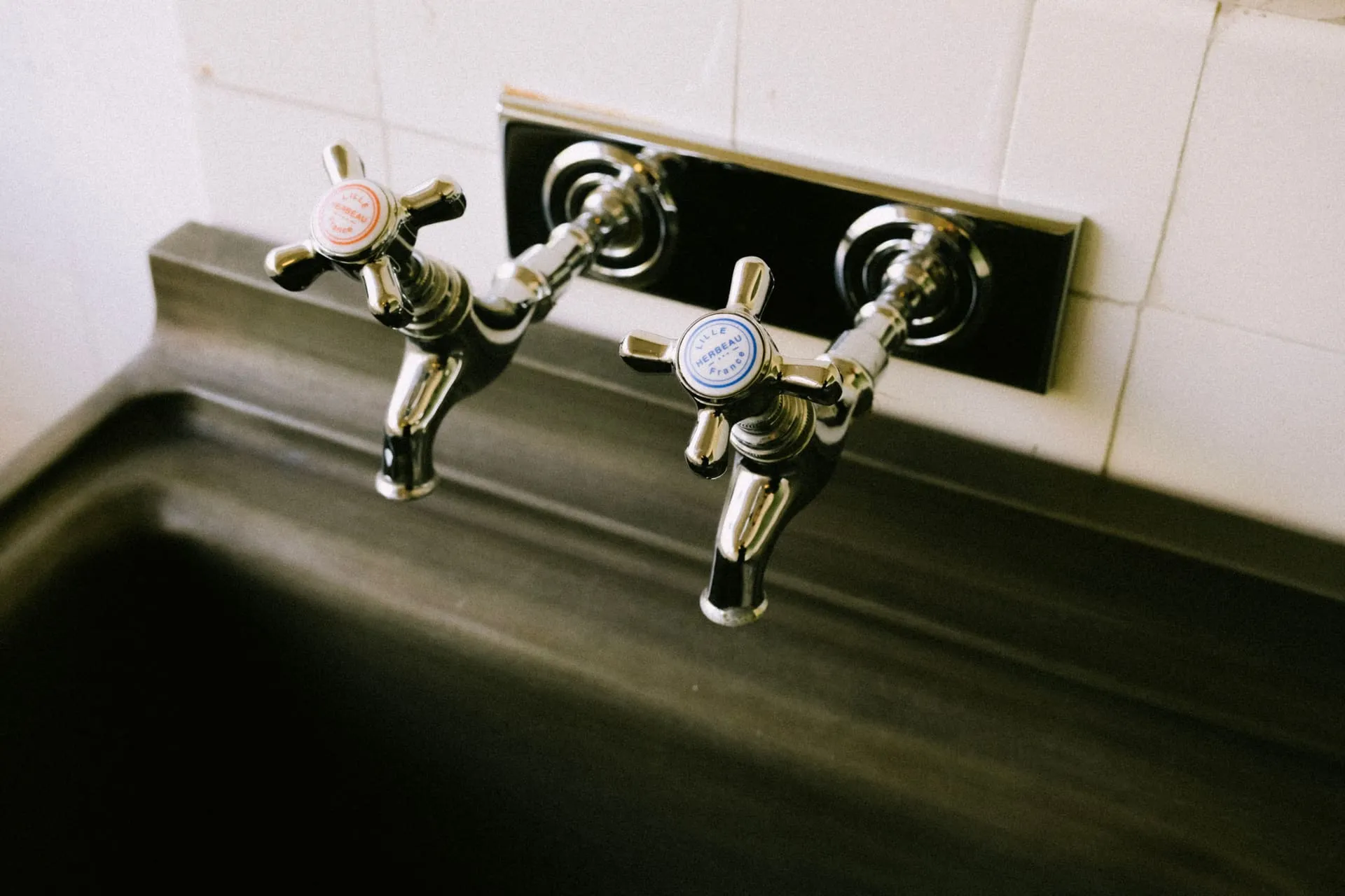Chrome hot and cold taps above a kitchen sink when there is no hot water