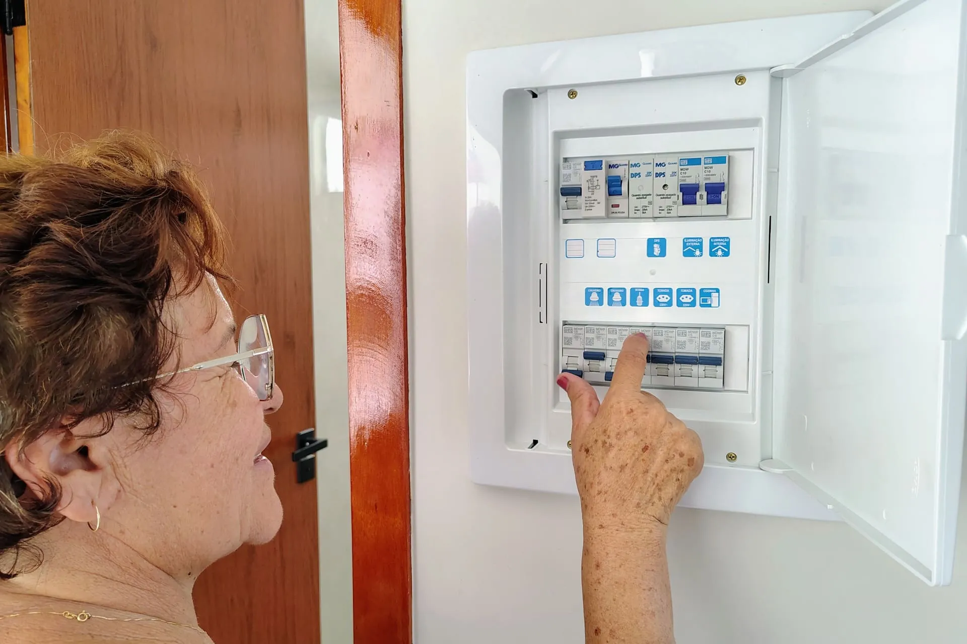 Homeowner checking a switchboard after a safety switch tripping fault cut the power