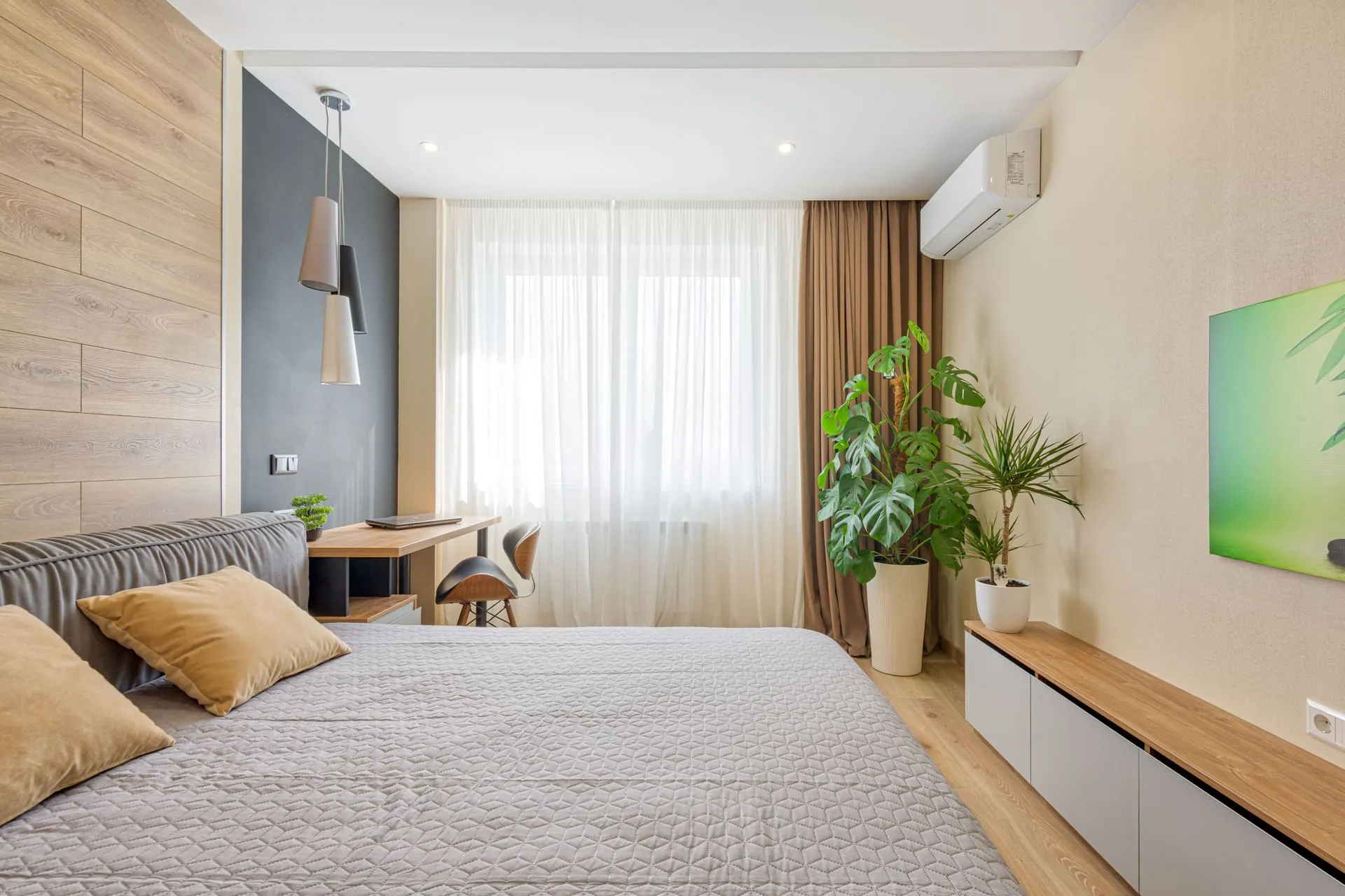 Bedroom with a wall-mounted split system, showing split system air conditioner installation cost outcomes